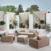 Elegant Como Natural Antique Outdoor Seating Set arranged in a serene garden setting. This outdoor lounge set features a two-seater sofa, two armchairs, and a versatile footstool, all crafted from weather-resistant synthetic rattan in a natural antique finish. The seating is enhanced with soft beige cushions for ultimate comfort, creating a stylish and relaxing outdoor space.