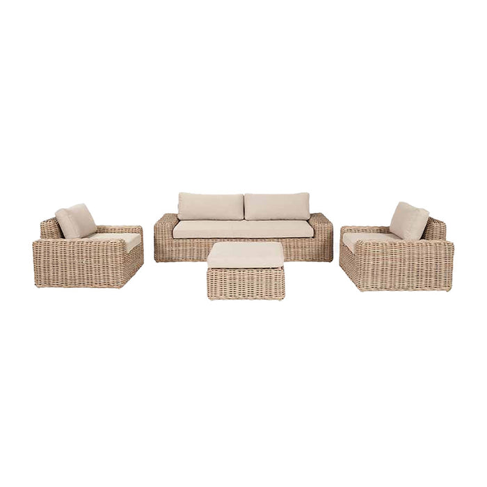 Front view of the Como Natural Antique Outdoor Seating Set showcasing the full set including a two-seater sofa, two armchairs, and a footstool. Each piece is crafted from durable synthetic rattan with a natural antique finish, paired with plush beige cushions that offer both style and comfort.