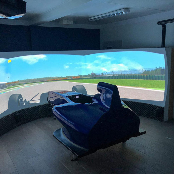 Cool Performance F1 Half Cockpit racing simulator with blue Formula-style cockpit surrounded by a large panoramic projection screen for professional racing simulation.