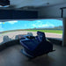 Cool Performance F1 Half Cockpit racing simulator with blue Formula-style cockpit surrounded by a large panoramic projection screen for professional racing simulation.
