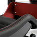 Cool Performance Formula Pro Racing Simulator black leather seat bolster macro close-up showing double red contrast stitching detail with red powder-coated chassis panel in background.