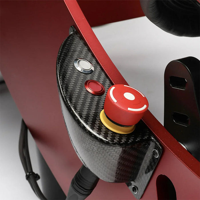 Cool Performance Formula Pro Racing Simulator carbon fibre side panel close-up showing red emergency stop button with yellow collar, chrome button, and red function button mounted on red chassis frame.