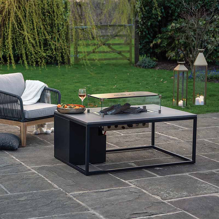 A contemporary Cosiloft 120 Fire Pit Table with a straight glass surround, enhancing the outdoor setting and providing a stylish focal point.