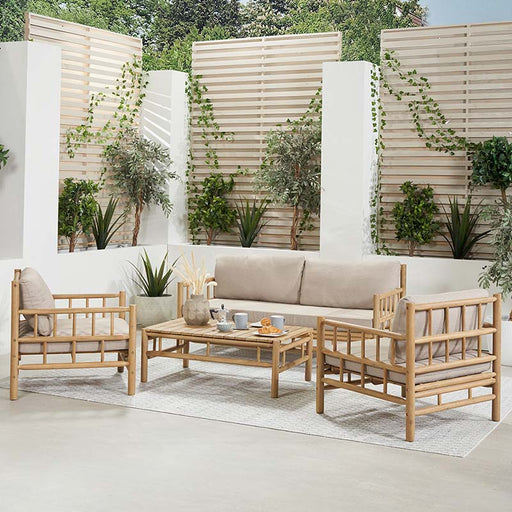 The Costa Rica Natural Bamboo Outdoor Seating Set featuring a two-seater sofa, two armchairs, and a rectangular coffee table. All pieces have a natural bamboo effect acacia wood frame and beige cushions.