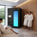 Black Cryo-iCConiQ PRO electric cryochamber in an upscale wellness room with users relaxing nearby, demonstrating its integration in luxury spa settings.