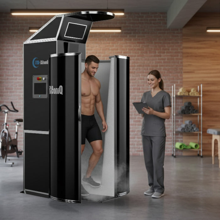 Cryo-iCConiQ SOLO nitrogen cryosauna in an active fitness centre, with a male client exiting the chamber and a female technician monitoring results on a tablet.