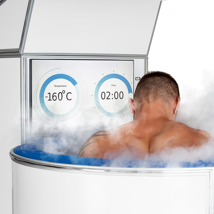 Man undergoing cryotherapy session inside the Cryo-iCConiQ SOLO nitrogen cryosauna, with temperature display showing -160°C and 2-minute countdown, surrounded by therapeutic mist.