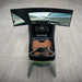 Curv AMR-C01-R Aston Martin Racing Simulator cockpit photographed from directly above showing brown leather racing seat, carbon fibre interior, Formula steering wheel with colour display, and curved triple-screen setup displaying Silverstone circuit