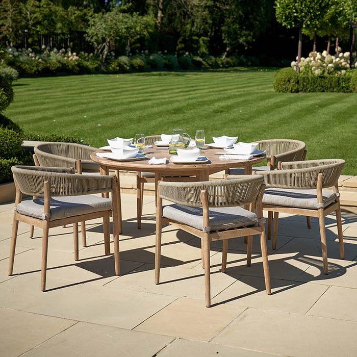 Denver Outdoor 6 Seater Dining Set arranged in a lush garden, showcasing its elegant acacia wood frame and comfortable, weather-resistant cushions, perfect for alfresco dining.