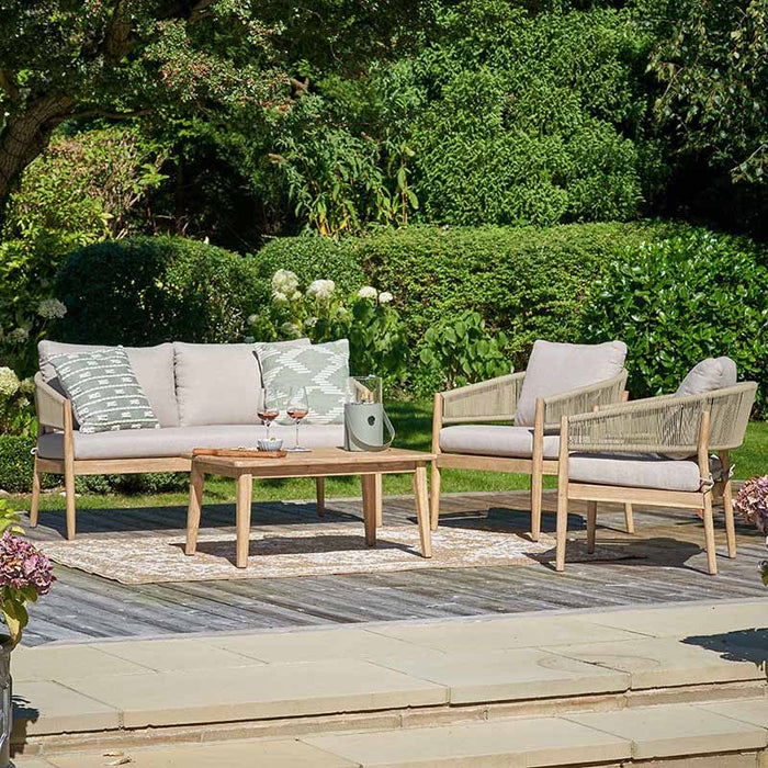 Denver Outdoor Seating Set in garden, surrounded by green plants. 