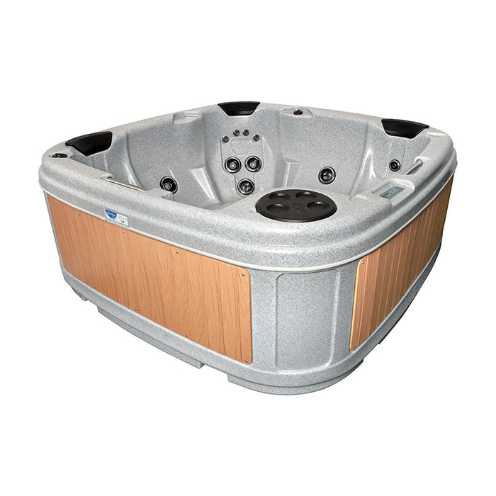 Empty light grey hot tub with beige panels and cover off, ready for use