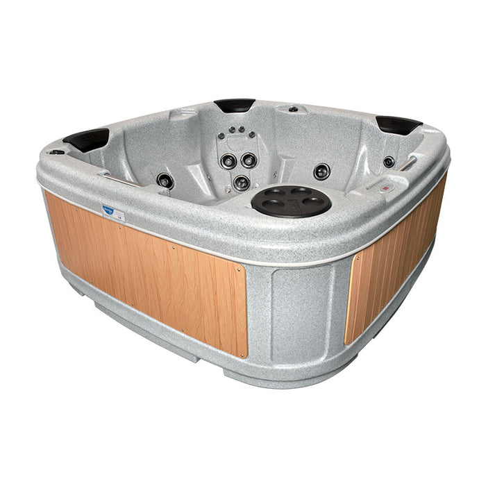 Empty light grey hot tub with beige panels and cover off, ready for use