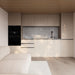 Contemporary kitchenette in Estholz Garden House WILLIAM featuring sleek cabinetry, a marble backsplash, integrated appliances, and a neutral palette.