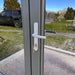 Close-up of a secure grey aluminium door with a silver handle and key lock on the Estholz Garden House WILLIAM.