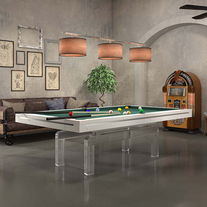 Etrusco Contemporaneo pool table with fresh white frame, green cloth, and transparent acrylic legs in an open-plan loft room.