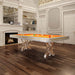 Etrusco Narciso pool table with bright orange cloth and shining chrome legs, displayed in a grand room with rich wooden flooring.