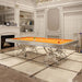 Etrusco Narciso pool table with vibrant orange felt and triple-floral chrome base, showcased in an elegant classical room with marble flooring.