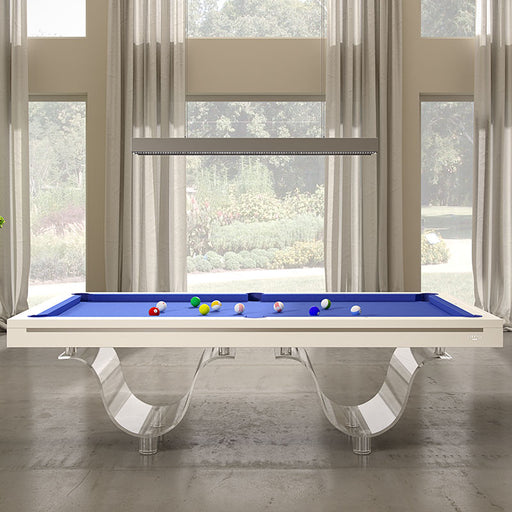 Front-facing view of the Etrusco Onda Marina Pool Table featuring blue felt and acrylic curved legs, set against large windows with elegant curtains.