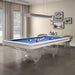 Etrusco Onda Marina Pool Table with bright blue cloth and clear wave-style legs, positioned in a modern room with natural light and framed wall art.