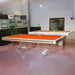Etrusco Onda Marina Pool Table with striking orange cloth and signature acrylic curved legs, displayed in a chic convertible room setting.
