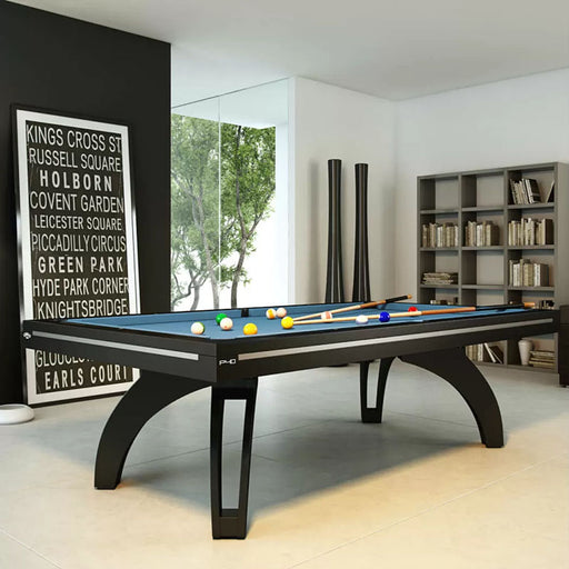 Etrusco P40 contemporary pool table in matte black finish with vibrant blue cloth, set in a sleek home interior with floor-to-ceiling windows, artistic décor, and minimalist shelving.