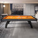 Etrusco P40 contemporary pool table with black curved legs and bold orange cloth, positioned in a luxurious city-view interior with soft lighting and modern furnishings.
