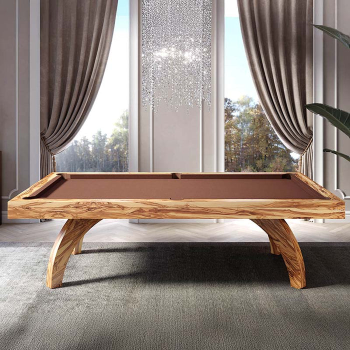 Etrusco P40 pool table with a natural olive wood finish and brown cloth, showcased in an elegant room with floor-to-ceiling curtains and crystal chandelier, combining modern billiards design with luxury interiors.