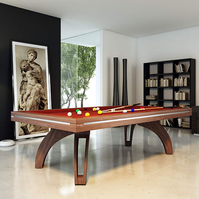 Etrusco P40 walnut pool table with deep red cloth and sculpted wooden legs, displayed in a stylish interior with large windows, monochrome decor, and art-inspired design.