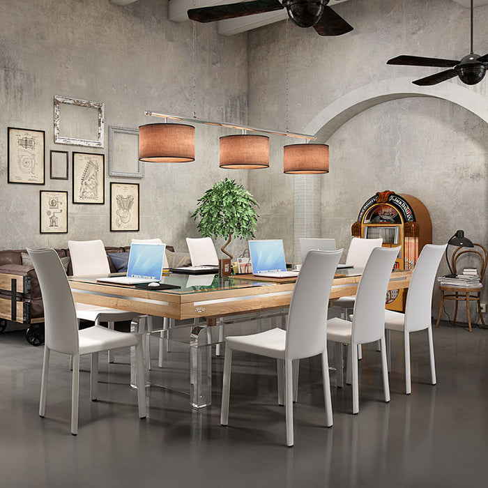Convertible Etrusco P50 pool and dining table with wood finish, clear legs, and white chairs set up for a meeting.