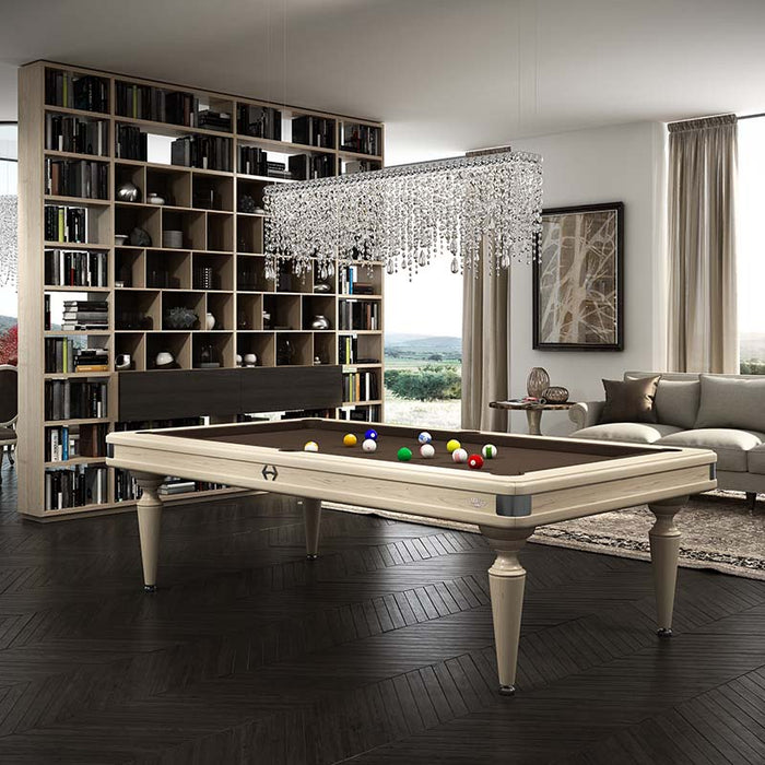 Etrusco Smile pool table with white wood finish and brown cloth in a classic-modern living space with bookcase backdrop.