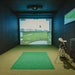 Professional indoor golf simulator setup with Foresight Falcon overhead launch monitor, club set, and wall-mounted displays in a dark acoustic room.