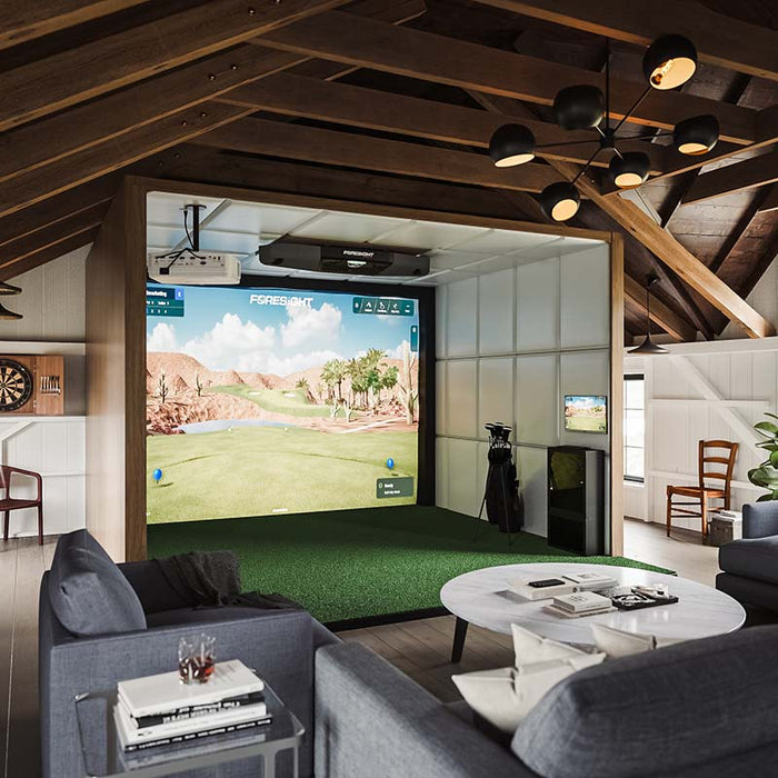 Spacious loft with Foresight Falcon overhead launch monitor and golf simulator bay, surrounded by lounge seating, wooden beams, and modern lighting.