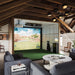Spacious loft with Foresight Falcon overhead launch monitor and golf simulator bay, surrounded by lounge seating, wooden beams, and modern lighting.