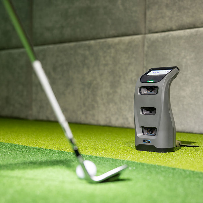 Foresight GC3 Launch Monitor indoors with a blurred golf club in motion, capturing swing data mid-action.