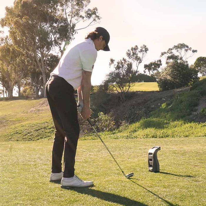 Golfer preparing to swing with Foresight GC3 Launch Monitor on-course, capturing real-time shot data.