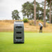 Foresight GC3 Launch Monitor placed on the green with a blurred golfer preparing to putt in the background.