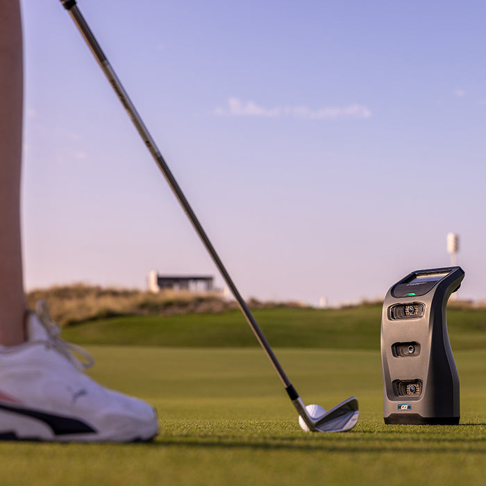 Foresight GC3 Launch Monitor positioned near golfer’s feet before putting stroke during twilight.