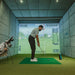 Golfer addressing golf ball in indoor simulator with Foresight GC3S Launch Monitor ready for shot data collection.