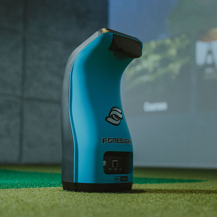 Side view of Foresight GC3S Launch Monitor placed on indoor turf, highlighting its sleek design and ergonomic structure.