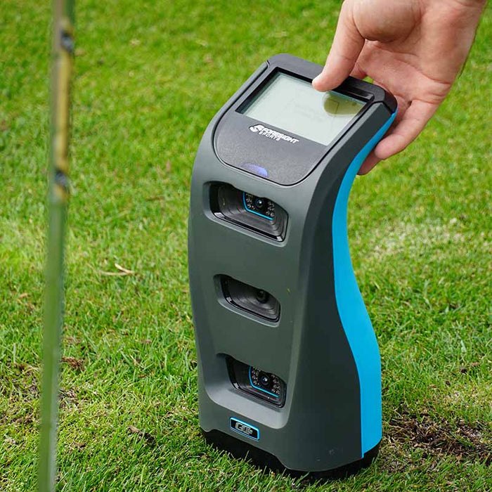 Close-up of golfer adjusting the touchscreen on the Foresight GC3S Launch Monitor, demonstrating user-friendly controls and settings.