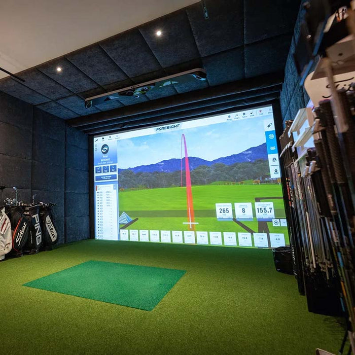 Golf retail simulator setup featuring Foresight GCHawk launch monitor and in-store club fitting area, designed for precision swing analysis.