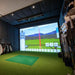 Golf retail simulator setup featuring Foresight GCHawk launch monitor and in-store club fitting area, designed for precision swing analysis.
