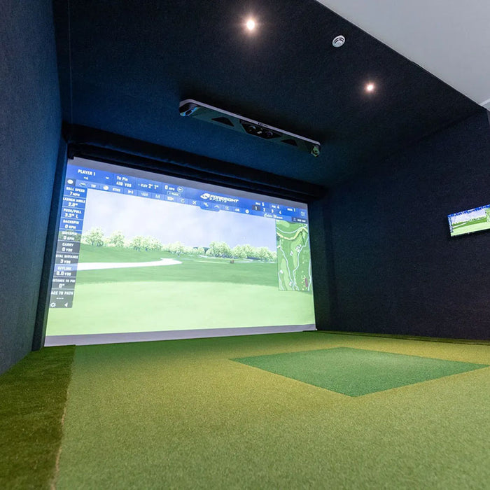 Spacious golf simulator setup with Foresight GCHawk overhead launch monitor and immersive course visuals displayed on screen.