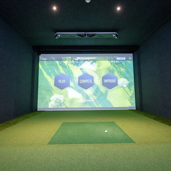 Straight-on view of a Foresight GCHawk-powered indoor golf simulator displaying “Play, Compete, Improve” interface for performance practice.