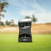 Outdoor close-up of Foresight GCQuad Launch Monitor on fairway with scenic background.