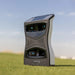 Close-up of the Foresight QuadMAX Launch Monitor on a golf course with clear sky background.
