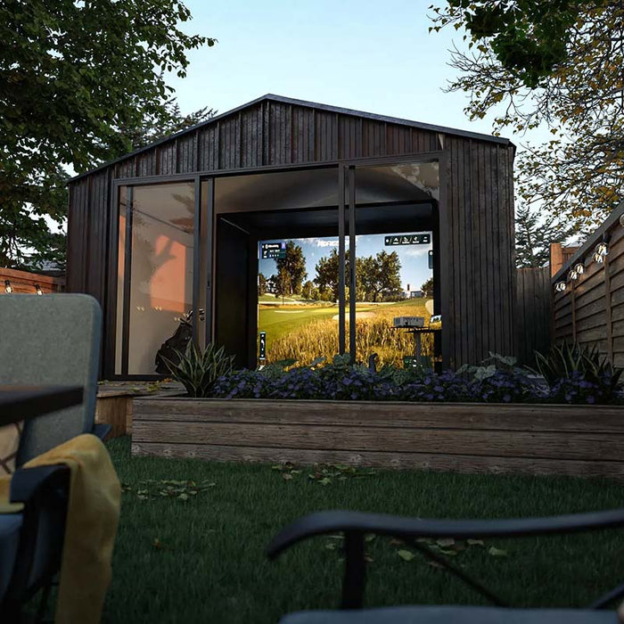 Modern garden golf simulator room with Foresight Sim-in-a-Box, showcasing a scenic virtual course in a stylish timber-clad studio.