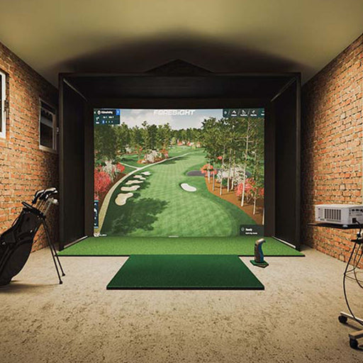 Interior view of Foresight Sim-in-a-Box Play Golf Simulator in brick-walled space, featuring dual golf bags, launch monitor, and immersive course graphics.