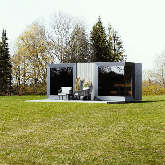 Angled perspective of Geneva St. Moritz outdoor sauna cabin, showing bold lines, dual glass panels and clean landscaping.