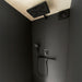 Stylish matte black shower system inside Geneva St. Moritz outdoor sauna’s shower room, featuring a rainfall head and minimalist design.